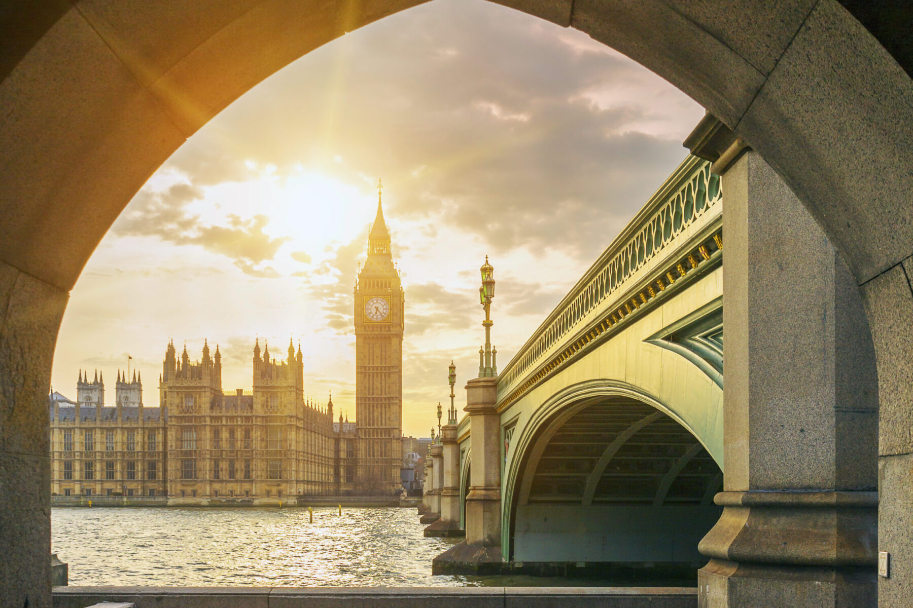 View of Big Ben and sun through the pedestrian tunnel at sunset, London.